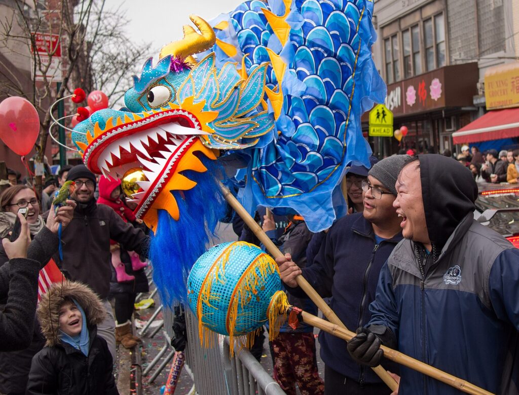 A dragon encounters a bird at the 2018 Chinese New Year / Lunar New Year parade in New York City.