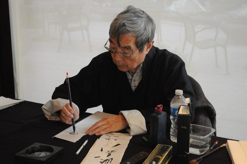 Chinese calligrapher at Lunar New Year event, Trammell & Margaret Crow Collection of Asian Art, Dallas, Texas, USA.