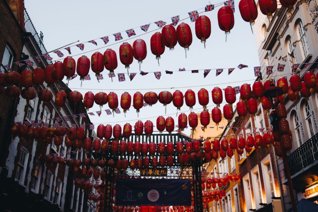 Colorful red lanterns line the streets of Chinatown in London, capturing a vibrant festive atmosphere.