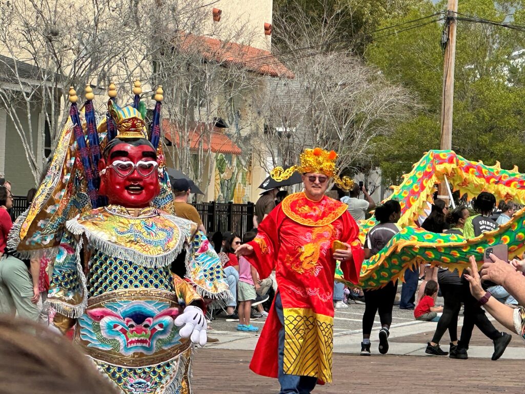 Costumed participants as Cai Shen and Electric-Techno Neon God Taiwan community Orlando in Central Florida Dragon Parade